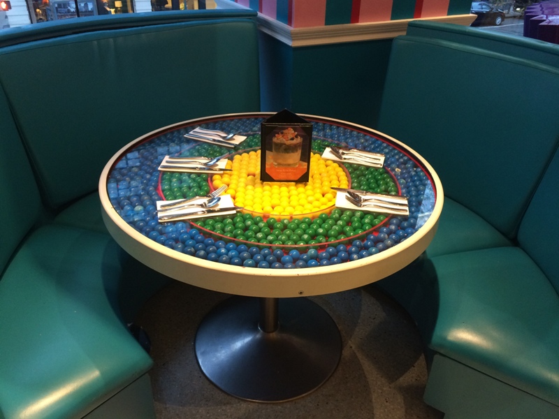 Tables in the cafe are filled with gumballs.