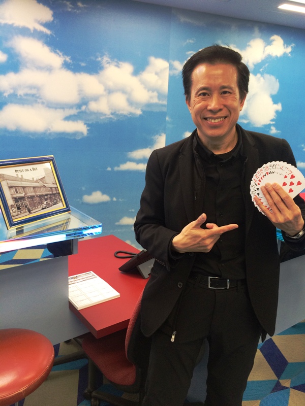 Rod Chow entertains visitors with amazing card tricks.