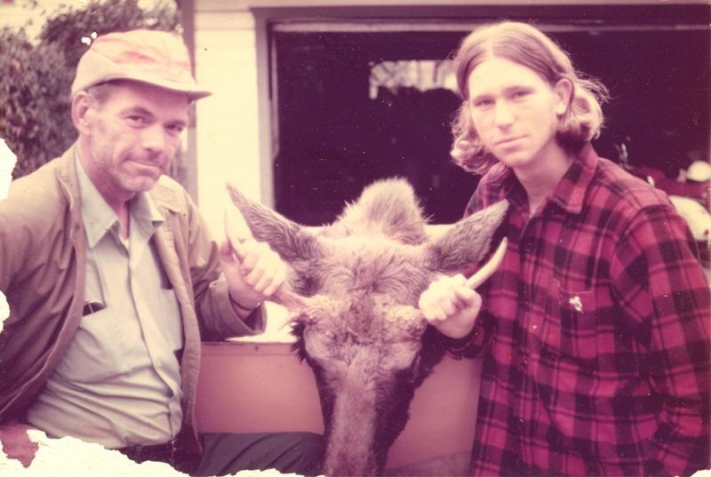 My father and I with the head of our prized moose in Uncle Del’s driveway after our trip.